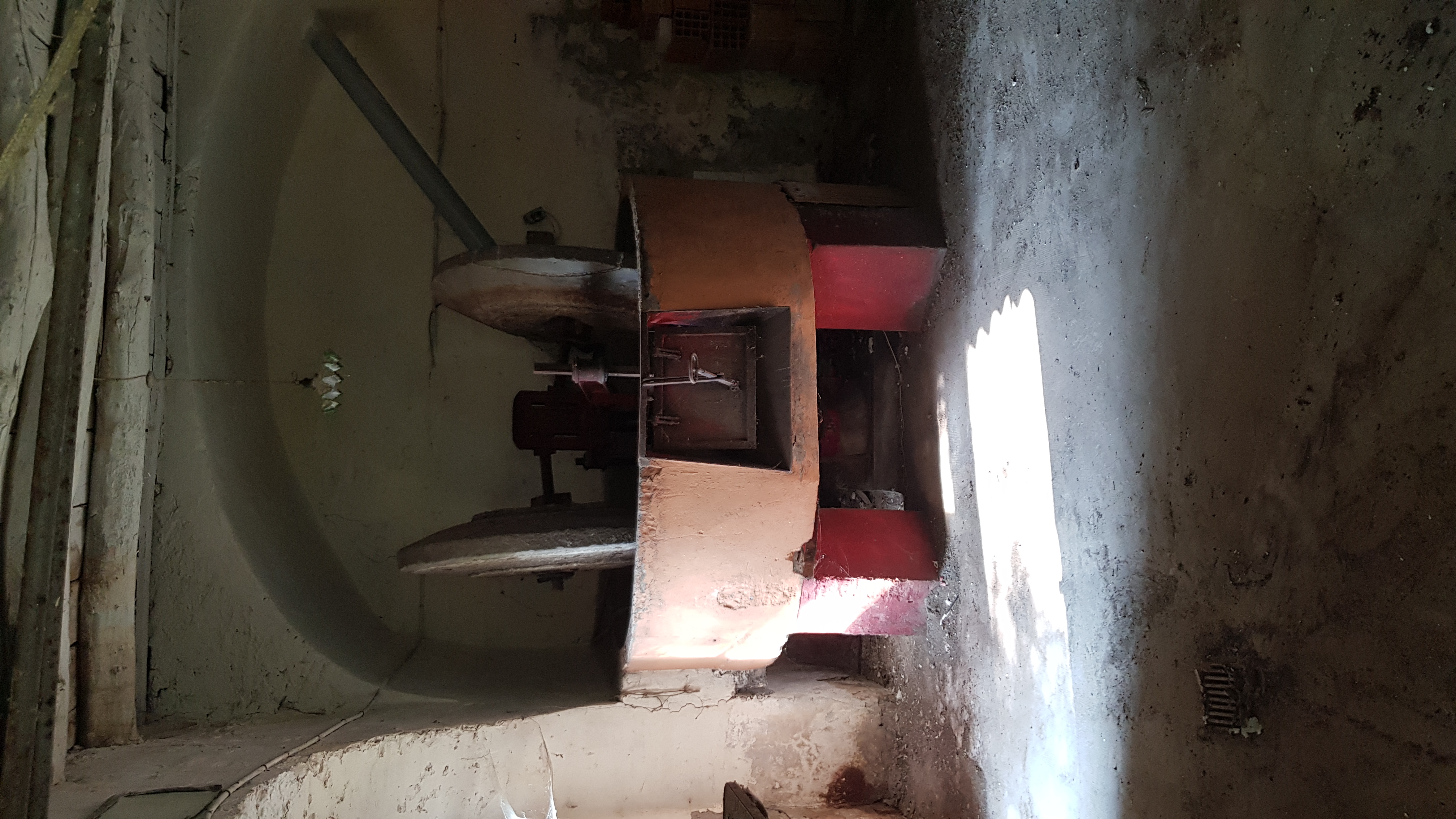 Millstone beneath the arched vault — oil mill