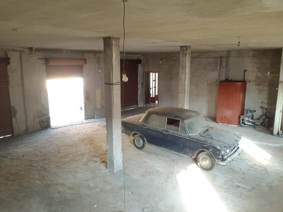 Open door with shaft of light and vintage Fiat